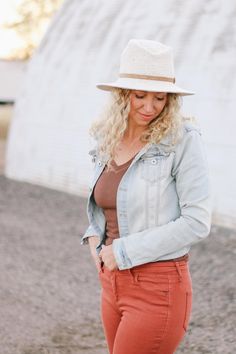 a woman wearing red pants and a white hat