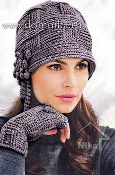 a woman wearing a knitted hat and mittens with her hand on her shoulder