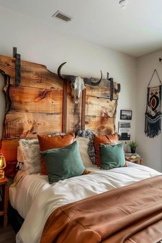 a large bed sitting in a bedroom next to a wooden headboard with deer heads on it