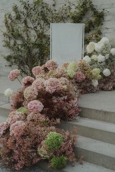 some flowers are sitting on the steps outside