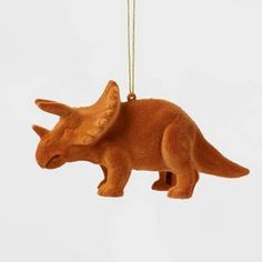 an ornament shaped like a rhinoceros is hanging from a gold chain