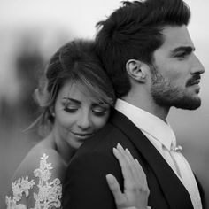 a bride and groom embracing each other in black and white