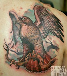 an eagle tattoo on the back of a man's shoulder