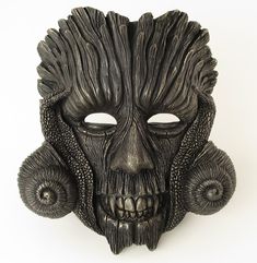 This unique and stunning mask, individually sculpted and handpainted, looks great on a wall and can be worn for parties.  The creation of this mask was inspired by the character of Green Man and His mysterious dark night aspect. This one-of-a-kind original art piece, which you can wear on various occasions or simply display it as a striking and eye-catching home ornament, is made of mixed resin and talc as well as fiberglass cloth. It was created through a complex process, which started with modelling the mask in Plasticine modelling clay and producing a handmade silicone mold. Later it was painted by hand with high quality artistic acrylic paints - black and metallic - and fine tip paint brushes. Height: 22 cm/ 8.7 in Width: 20 cm/ 7.9 in Depth: 11 cm/ 4.3 in Weight: 403 g/ 14.2 oz Artistic Halloween Costume Masks, Fantasy Eye Mask For Themed Events, Artistic Masks For Halloween Masquerade, Artistic Masks For Halloween Costume Party, Artistic Halloween Mask For Costume Party, Artistic Masks For Masquerade And Halloween, Artistic Halloween Masks For Fantasy Events, Artistic Halloween Masquerade Masks, Artistic Black Masks And Prosthetics For Halloween