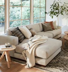 a living room filled with furniture and lots of window sill space next to a couch