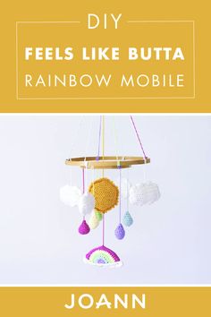 a mobile made out of yarn with the words, diy feels like butta rainbow mobile