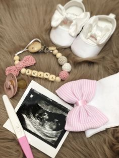 a baby's booties, pacifier and other items are laid out on a fur surface