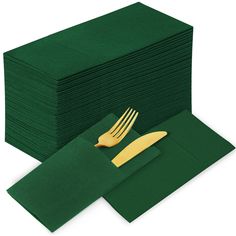 a stack of green napkins with gold forks