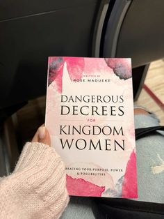 a person holding up a book in their hand that reads dangerous degrees for kingdom women