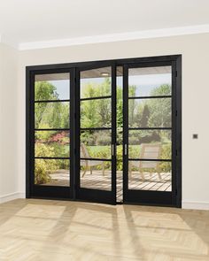 an empty room with sliding glass doors and wood flooring