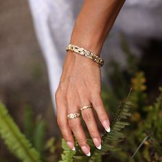 a close up of a person's hand with two rings on it