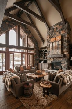 a living room filled with furniture and a stone fireplace