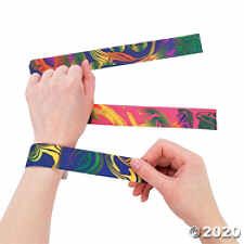 two hands are holding colorful wristbands in front of each other