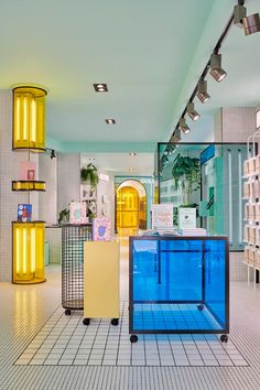 the inside of a store with blue and yellow glass cases in it's center