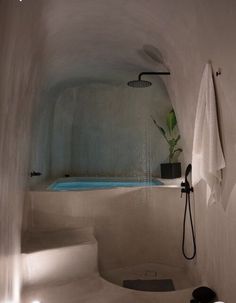 a bathroom with a tub and shower head