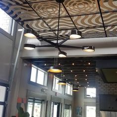 the ceiling is decorated with zebra print and hanging from it's metal beams,