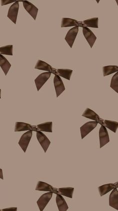 a brown bow pattern on a tan background