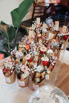 small vases filled with flowers on top of a table