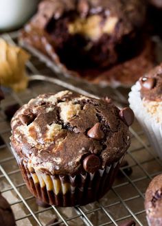 chocolate chip muffins cooling on a wire rack next to other muffins