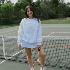 Serve up some style with this cute and classy tennis club crew. This classic style is perfect for a day on the court or just sipping some lemonade at your local country club. Pair with a cute tennis skirt or our simple belt bag for the perfect preppy outfit. This white crew will have your sorority name embroidered in green thread about two cute tennis rackets and your sorority's established date on either side. Model is wearing a size large White crew with bright pink and green embroidery Country Club Preppy Outfit, White Preppy Tennis Dress For Spring, Casual White Tennis Dress, Trendy White Tennis Skirt For School, Tennis Skirt Outfit Athletic, White Preppy Tennis Skirt For School, Preppy Tennis Dress For Spring, Preppy Spring Tennis Dress, Spring Preppy Tennis Dress