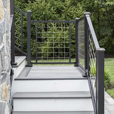 a set of stairs leading up to the top of a stone building with metal railings