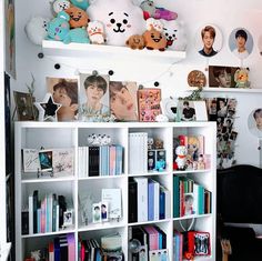 a book shelf filled with lots of books and stuffed animals on top of it's shelves