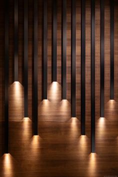 an image of some lights that are on the side of a wooden wall or floor