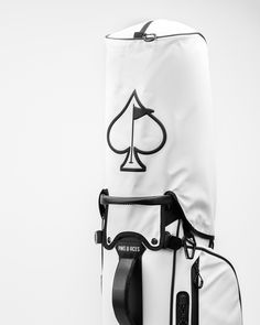 the back side of a white bag with a black and white ace symbol on it