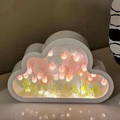 there is a light up cloud with flowers in it