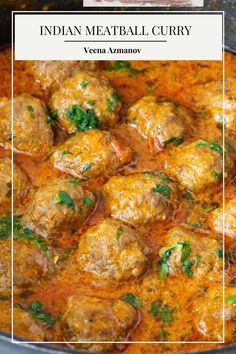 meatball curry in a red sauce with green garnish on the top and bottom