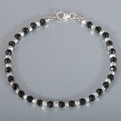 Silver Crystal Bracelet With Black Beads, Faceted Sterling Silver Beaded Bracelets, Silver Beaded Bracelets With Black Round Beads, Silver Faceted Rondelle Crystal Bracelet, Silver Bracelet With Round Black Beads, Silver Bracelets With Black Round Beads, Silver Bracelet Jewelry With Black Beads, Elegant Silver Rondelle Beads, Silver Rondelle Bracelets With Silver Beads