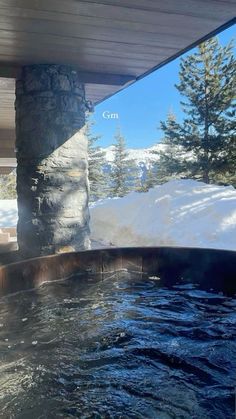 an outdoor hot tub with snow on the ground