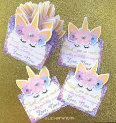 three unicorn themed birthday cards on a table