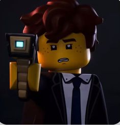 the lego movie character is holding a camera