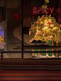 a store front with christmas decorations in the window and lights hanging from the windows behind it