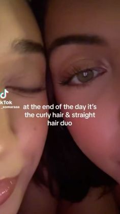 two women with their eyes closed and the words at the end of the day it's the curly hair & straight hair duo