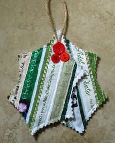 an ornament made out of torn fabric with buttons on the front and back