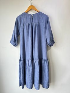 Beaton Cornflower Blue Linen Dress. The prettiest color! Perfectly flowy with tiered pleats to add some texture and volume. Button closure short sleeves and big pockets. Machine wash cold and line dry, marked size Sm. Approximate measurements:Underarm to underarm: 18"Length: 40" Relaxed Fit Short Sleeve Dresses With Ruffle Hem, Spring Tiered Dress With Pockets, Light Blue Short Sleeve Maxi Dress With Ruffles, Light Blue Maxi Dress With Ruffles And Short Sleeves, Blue Short Sleeve Pleated Maxi Dress, Modest Blue Midi Dress With Short Sleeves, Blue Casual Flowy Tiered Dress, Casual Blue Flowy Tiered Dress, Casual Blue Tiered Dress With Loose Fit