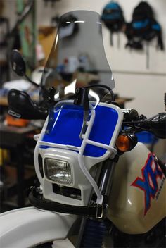 a white and blue motorcycle parked in a garage