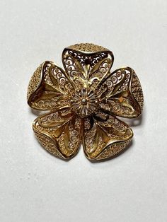 Beautiful sterling silver, gold overlay, vermeil brooch from Germany ! It is 1-1/2 in in diameter. The clasp works well. Elegant Gold Filigree Brooches, Gold Flower Jewelry With Intricate Design, Antique Yellow Gold Filigree Brooches, Yellow Gold Filigree Brooches For Wedding, Wedding Yellow Gold Filigree Brooches, Heirloom Gold Brooch With Intricate Design, Heirloom Gold Brooches With Intricate Design, Yellow Gold Flower Brooch Jewelry, Yellow Gold Flower Brooch