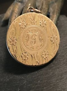 "Early 1900s hand engraved floral motif large round locket.  Condition is good for it's age-the inside has soft solder  from previous owner-pictures will cover it and it does not effect the design when closed.  size 1 1/8\" in diameter, monogram I believe is a G.  Artistically engraved." Victorian Style Medallion Coin Pendant Jewelry, Ornate Medallion Locket Necklace With Vintage Charm, Vintage Oval Jewelry With Coin Pendant, Ornate Engraved Medallion Locket Necklace, Victorian Medallion Locket Necklace With Vintage Charm, Victorian Vintage Charm Round Locket Necklace, Victorian Medallion Locket Necklace Hallmarked, Ornate Engraved Round Locket Necklace, Victorian Style Vintage Charm Round Locket Necklace