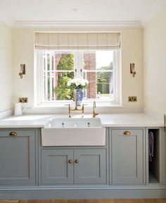 a white sink sitting under a window in a kitchen