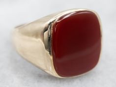 This beautiful Mid-Century mounting combines sleek styling and intense color. This beautifully styled ring with a warm rich Carnelian center. Carnelian is the reddish-orange version of Chalcedony and can either be uniformly colored or have visible bands through the stone.Material: 10K Yellow GoldGem: CarnelianGem Measurements: 13.9 x 16.2 mm, Rectangle Cushion Cut Size of Ring: 9.50Marks: "JASON 10K" Stamped on the inside band Modern Red Rings For Formal Occasions, Modern Red Ring For Formal Occasions, Classic Carnelian Signet Ring With Polished Finish, Classic Carnelian Signet Ring For Formal Occasions, Classic Carnelian Signet Ring For Formal Events, Red Carnelian Ring With Polished Finish, Classic Red Signet Ring For Formal Occasions, Red Carnelian Rings With Polished Finish, Red Polished Carnelian Rings