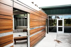 a wooden bench sitting in front of a building