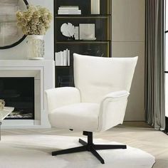 a white chair sitting in front of a fireplace