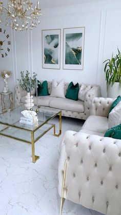 a living room filled with white couches and green pillows