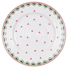 a white plate with red and green designs on the rim, against a white background