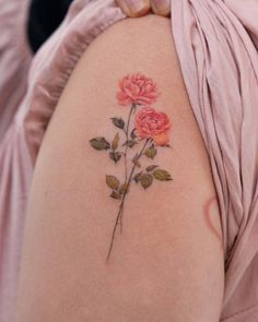 a close up of a person's arm with flowers on the back of it