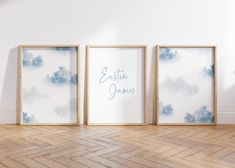 three empty frames on the wall in an empty room with wood flooring and white walls