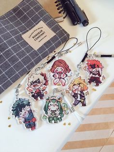 the keychain is decorated with anime characters on it's side, along with other items